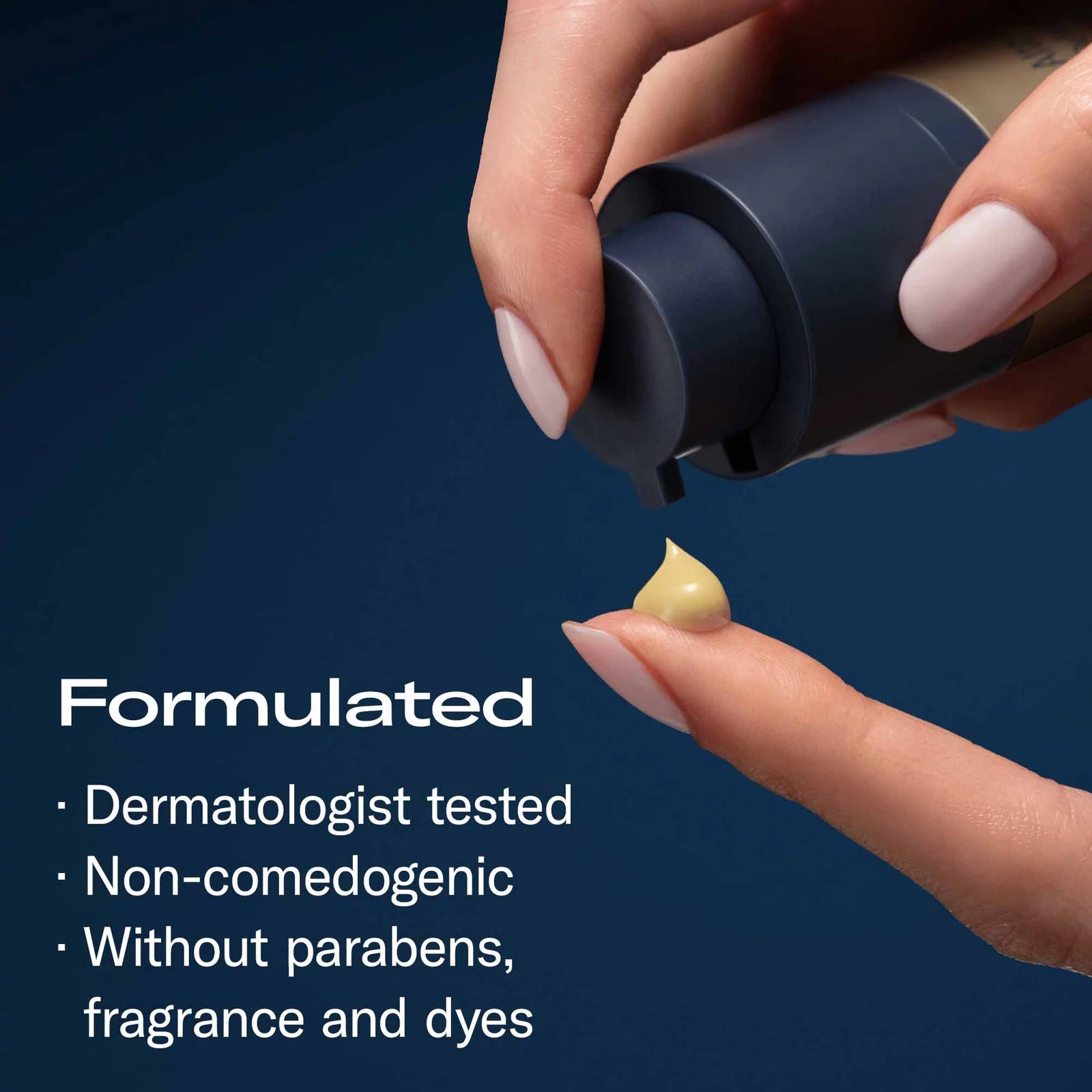 A close-up of a hand dispensing a small dollop of pale yellow cosmetic cream onto another finger, with marketing text on a dark blue background stating it is formulated, dermatologist tested, non-comedogenic, and free of parabens, fragrance, and dyes.
