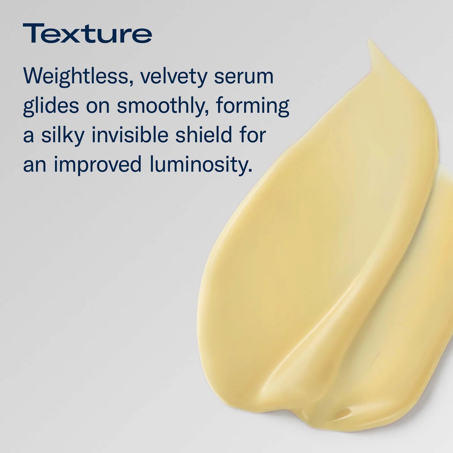 A pale yellow cream product smear on a light gray background with dark blue text describing a weightless, velvety texture and silky finish.
